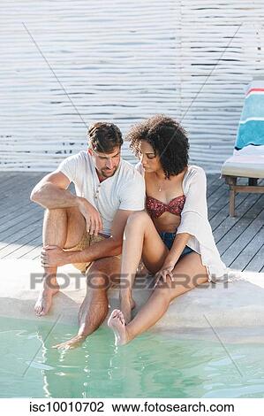 Couple in deep thought by swimming pool View Large Photo Image Stock Image - Couple in deep thought by swimming pool. Fotosearch