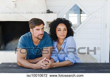 Couple in deep thought in beach house View Large Photo Image Stock Image - Couple in deep thought in beach house. Fotosearch