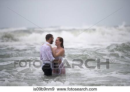 Stock Photo - Couple in embrace in sea. Fotosearch