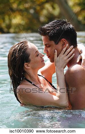 Couple kissing in swimming pool View Large Photo Image Stock Image - Couple kissing in swimming pool. Fotosearch
