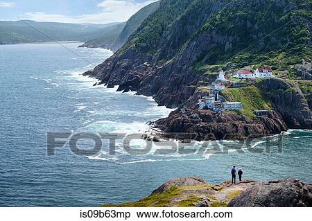 Couple looking out from coastal cliff, St John's, Newfoundland, Canada View Large Photo Image Stock Photography - Couple looking out from coastal cliff, St John's, Newfoundland, Canada. Fotosearch