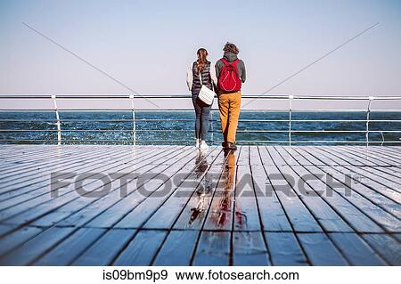 Couple looking out to sea View Large Photo Image Stock Photo - Couple looking out to sea. Fotosearch