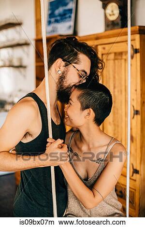 Couple on indoor swing View Large Photo Image Picture - Couple on indoor swing. Fotosearch