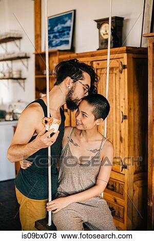 Couple on indoor swing View Large Photo Image Stock Photo - Couple on indoor swing. Fotosearch