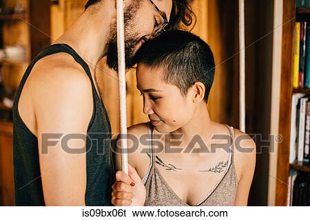 Stock Photograph - Couple on indoor swing. Fotosearch