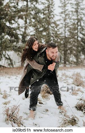 Couple playing piggyback in snowy landscape, Georgetown, Canada View Large Photo Image Stock Image - Couple playing piggyback in snowy landscape, Georgetown, Canada. Fotosearch