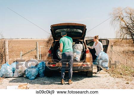 Couple putting rubbish bags into boot, Georgetown, Canada View Large Photo Image Stock Photo - Couple putting rubbish bags into boot, Georgetown, Canada. Fotosearch