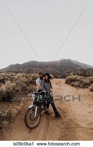 Couple relaxing on motorbike, Kennedy Meadows, California, US View Large Photo Image Stock Image - Couple relaxing on motorbike, Kennedy Meadows, California, US. Fotosearch