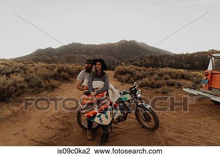 Couple relaxing on motorbike, Kennedy Meadows, California, US View Large Photo Image Stock Image - Couple relaxing on motorbike, Kennedy Meadows, California, US. Fotosearch