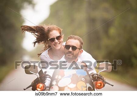 Couple riding on motorbike View Large Photo Image Stock Photo - Couple riding on motorbike. Fotosearch