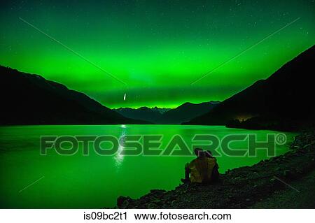 Couple sitting beside Lillooet Lake, watching northern lights, Pemberton, British Columbia, Canada View Large Photo Image Stock Image - Couple sitting beside Lillooet Lake, watching northern lights, Pemberton, British Columbia, Canada. Fotosearch