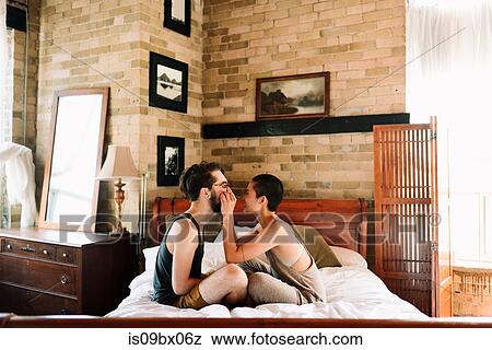 Couple sitting cross legged on bed View Large Photo Image Stock Photo - Couple sitting cross legged on bed. Fotosearch