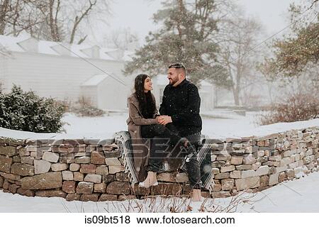 Couple sitting on blanket on stone wall, Georgetown, Canada View Large Photo Image Stock Photo - Couple sitting on blanket on stone wall, Georgetown, Canada. Fotosearch