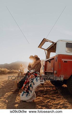 Couple sitting outside off road vehicle, Kennedy Meadows, California, US View Large Photo Image Stock Photo - Couple sitting outside off road vehicle, Kennedy Meadows, California, US. Fotosearch