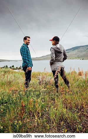 Stock Image - Couple standing beside Dillon Reservoir, Silverthorne, Colorado, USA. Fotosearch