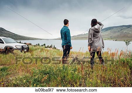 Stock Photo - Couple standing beside Dillon Reservoir, looking at view, Silverthorne, Colorado, USA. Fotosearch