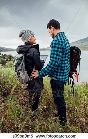 Stock Photography - Couple standing beside Dillon Reservoir, using digital tablet, Silverthorne, Colorado, USA. Fotosearch
