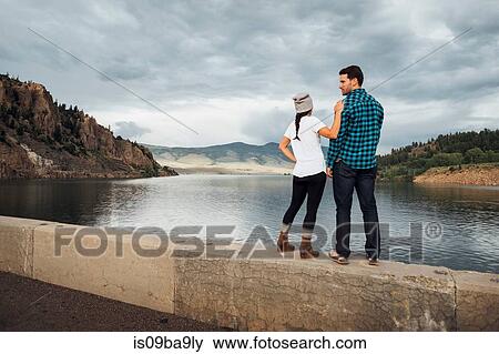 Couple standing on wall beside Dillon Reservoir, looking at view, rear view, Silverthorne, Colorado, USA View Large Photo Image Stock Photo - Couple standing on wall beside Dillon Reservoir, looking at view, rear view, Silverthorne, Colorado, USA. Fotosearch