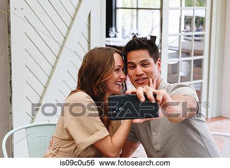 Couple taking selfie in restaurant, Cape Town, South Africa View Large Photo Image Stock Photograph - Couple taking selfie in restaurant, Cape Town, South Africa. Fotosearch