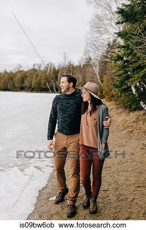 Couple walking along edge of snow field, Tobermory, Canada View Large Photo Image Stock Image - Couple walking along edge of snow field, Tobermory, Canada. Fotosearch