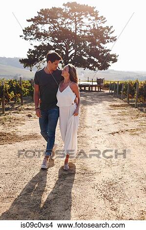 Couple walking along vineyard, Cape Town, South Africa View Large Photo Image Picture - Couple walking along vineyard, Cape Town, South Africa. Fotosearch