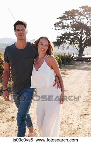 Couple walking along vineyard, Cape Town, South Africa View Large Photo Image Stock Photography - Couple walking along vineyard, Cape Town, South Africa. Fotosearch