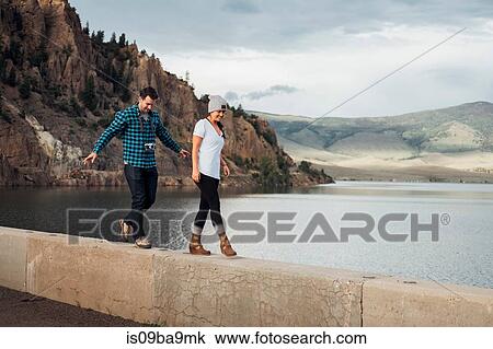 Couple walking along wall beside Dillon Reservoir, Silverthorne, Colorado, USA View Large Photo Image Stock Image - Couple walking along wall beside Dillon Reservoir, Silverthorne, Colorado, USA. Fotosearch