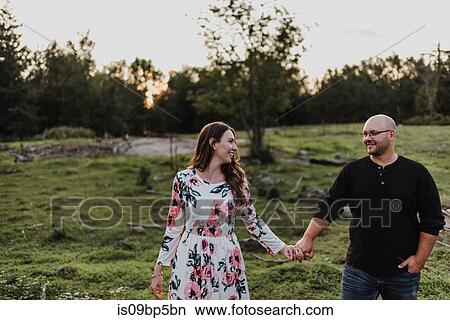 Couple walking in countryside View Large Photo Image Picture - Couple walking in countryside. Fotosearch