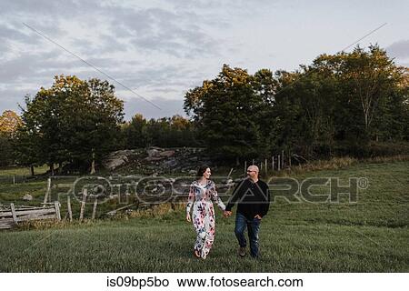Picture - Couple walking in countryside. Fotosearch