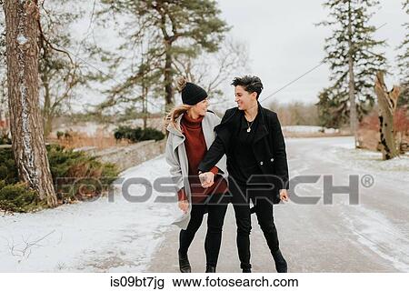 Couple walking in snowy landscape, Georgetown, Canada View Large Photo Image Stock Image - Couple walking in snowy landscape, Georgetown, Canada. Fotosearch