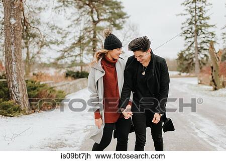 Couple walking in snowy landscape, Georgetown, Canada View Large Photo Image Stock Image - Couple walking in snowy landscape, Georgetown, Canada. Fotosearch