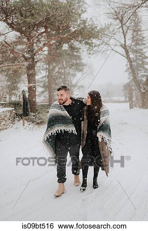 Stock Photograph - Couple walking in snowy landscape, Georgetown, Canada. Fotosearch