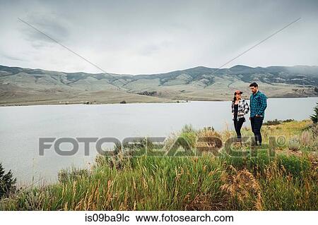 Stock Image - Couple walking near Dillon Reservoir, Silverthorne, Colorado, USA. Fotosearch