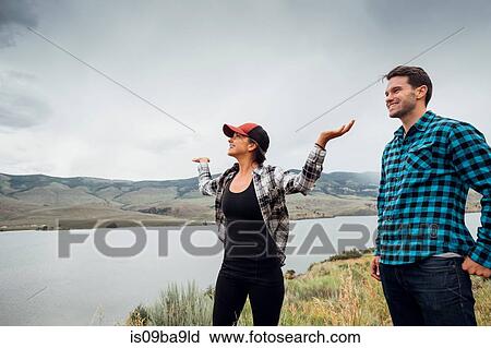 Couple walking near Dillon Reservoir, young woman's arms raised, Silverthorne, Colorado, USA View Large Photo Image Stock Image - Couple walking near Dillon Reservoir, young woman's arms raised, Silverthorne, Colorado, USA. Fotosearch