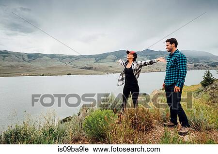 Couple walking near Dillon Reservoir, young woman's arms outstretched, Silverthorne, Colorado, USA View Large Photo Image Stock Image - Couple walking near Dillon Reservoir, young woman's arms outstretched, Silverthorne, Colorado, USA. Fotosearch