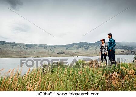 Stock Image - Couple walking near Dillon Reservoir, looking at view, Silverthorne, Colorado, USA. Fotosearch