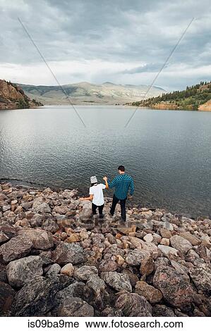 Couple walking on rocks beside Dillon Reservoir, elevated view, Silverthorne, Colorado, USA View Large Photo Image Stock Image - Couple walking on rocks beside Dillon Reservoir, elevated view, Silverthorne, Colorado, USA. Fotosearch