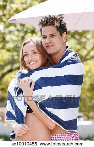 Couple wrapped in striped towel enjoying sun View Large Photo Image Stock Photography - Couple wrapped in striped towel enjoying sun. Fotosearch