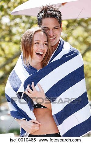 Couple wrapped in striped towel enjoying sun View Large Photo Image Stock Photography - Couple wrapped in striped towel enjoying sun. Fotosearch