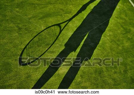 Cropped shadow of tennis player with tennis racket on green lawn View Large Photo Image Stock Image - Cropped shadow of tennis player with tennis racket on green lawn. Fotosearch