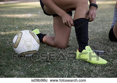 Cropped view of woman adjusting shin pad View Large Photo Image Stock Image - Cropped view of woman adjusting shin pad. Fotosearch