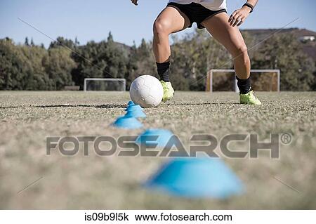 Cropped view of woman dribbling football View Large Photo Image Stock Image - Cropped view of woman dribbling football. Fotosearch