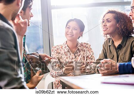 Stock Photograph - Digital design team meeting in office. Fotosearch