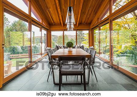 Stock Photograph - Dining table in gazebo of luxurious cedar wood home. Fotosearch