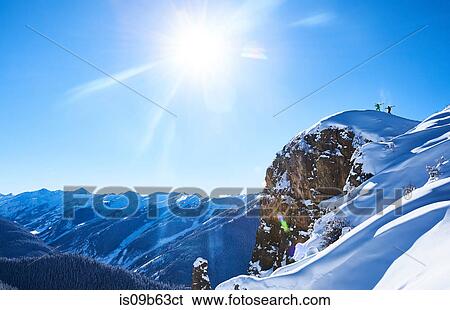 Distant view of two male skiers trudging up snow covered ridge, Aspen, Colorado, USA View Large Photo Image Stock Photograph - Distant view of two male skiers trudging up snow covered ridge, Aspen, Colorado, USA. Fotosearch