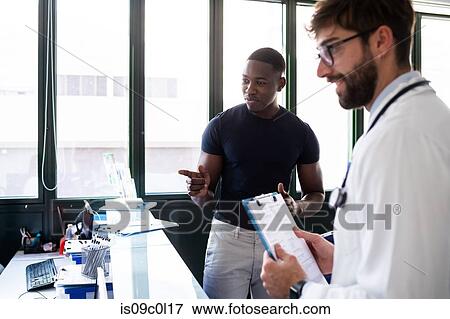 Doctor and patient at hospital reception View Large Photo Image Stock Photo - Doctor and patient at hospital reception. Fotosearch