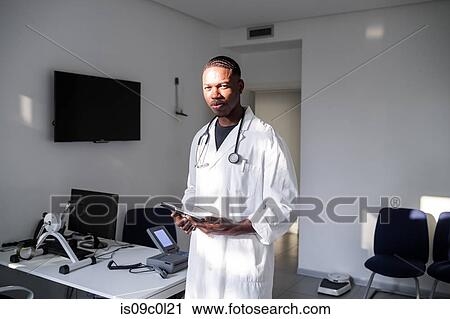 Stock Image - Doctor in consultation room. Fotosearch