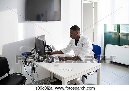 Doctor working on computer in hospital View Large Photo Image Stock Image - Doctor working on computer in hospital. Fotosearch