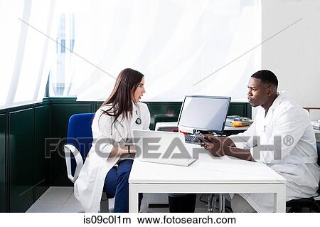 Doctors having discussion in meeting room View Large Photo Image Picture - Doctors having discussion in meeting room. Fotosearch