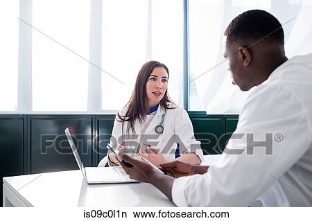 Doctors having discussion in meeting room View Large Photo Image Picture - Doctors having discussion in meeting room. Fotosearch